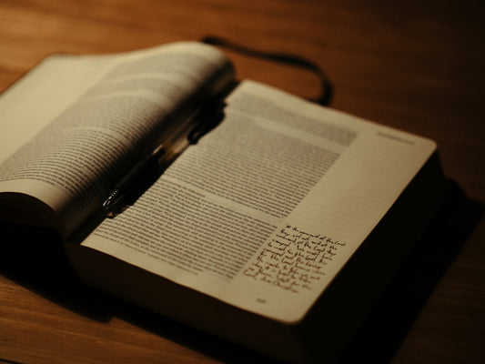 An open book sitting on top of a wooden table