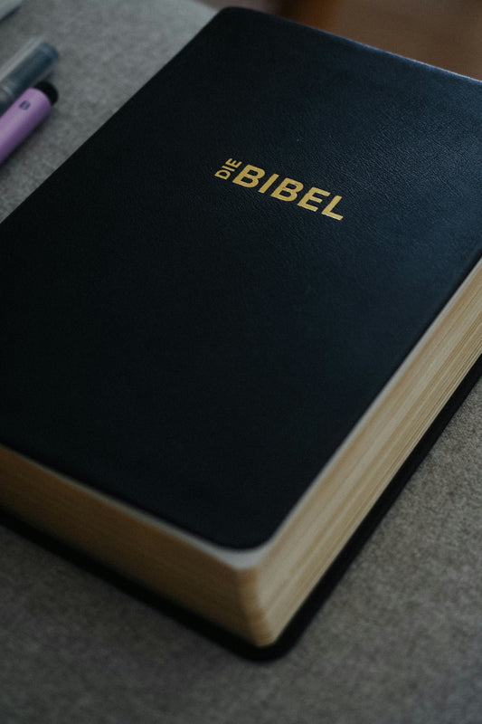 The bible sits on a surface.
